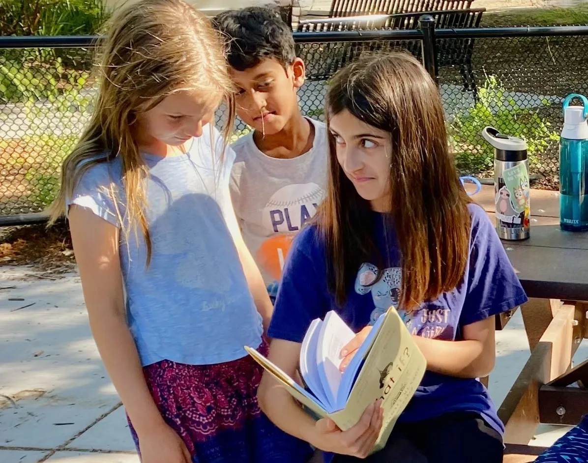 Three bright kids enjoy hypothetical physics situations presented in the brilliant book What If.